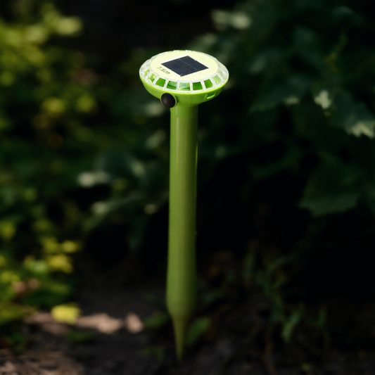 Solar-powered animal repellent in a garden setting