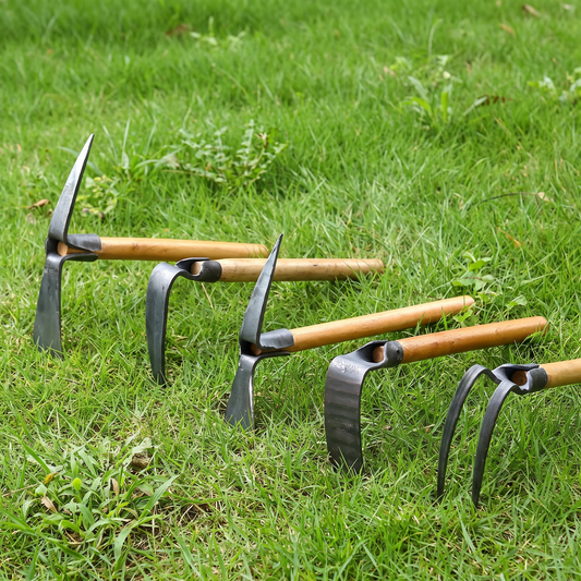 Hand-forged multi-head garden tools with wooden handles laid on grass